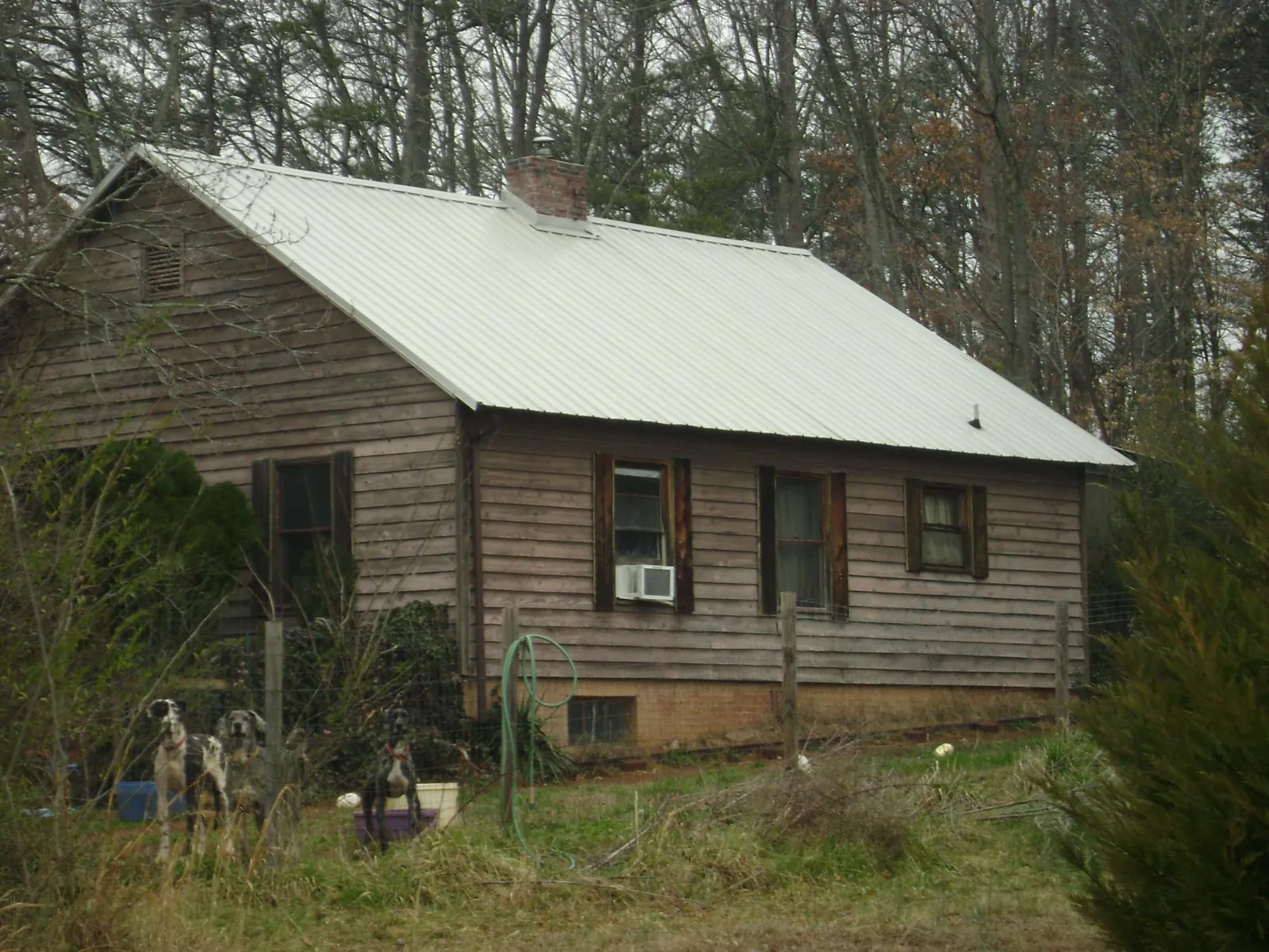 White metal roof on an old wood sided farmhouse, from a Metal Roof Installation job in Sutersville